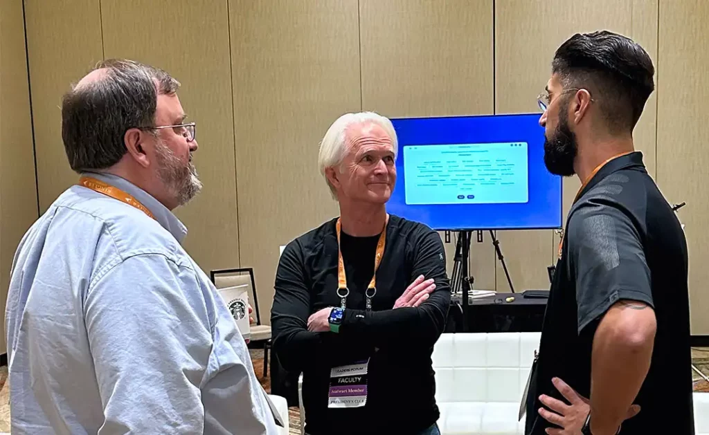 Metwork co-founder Tom Metier and COO Chris Matney talking with AAJ attendee.